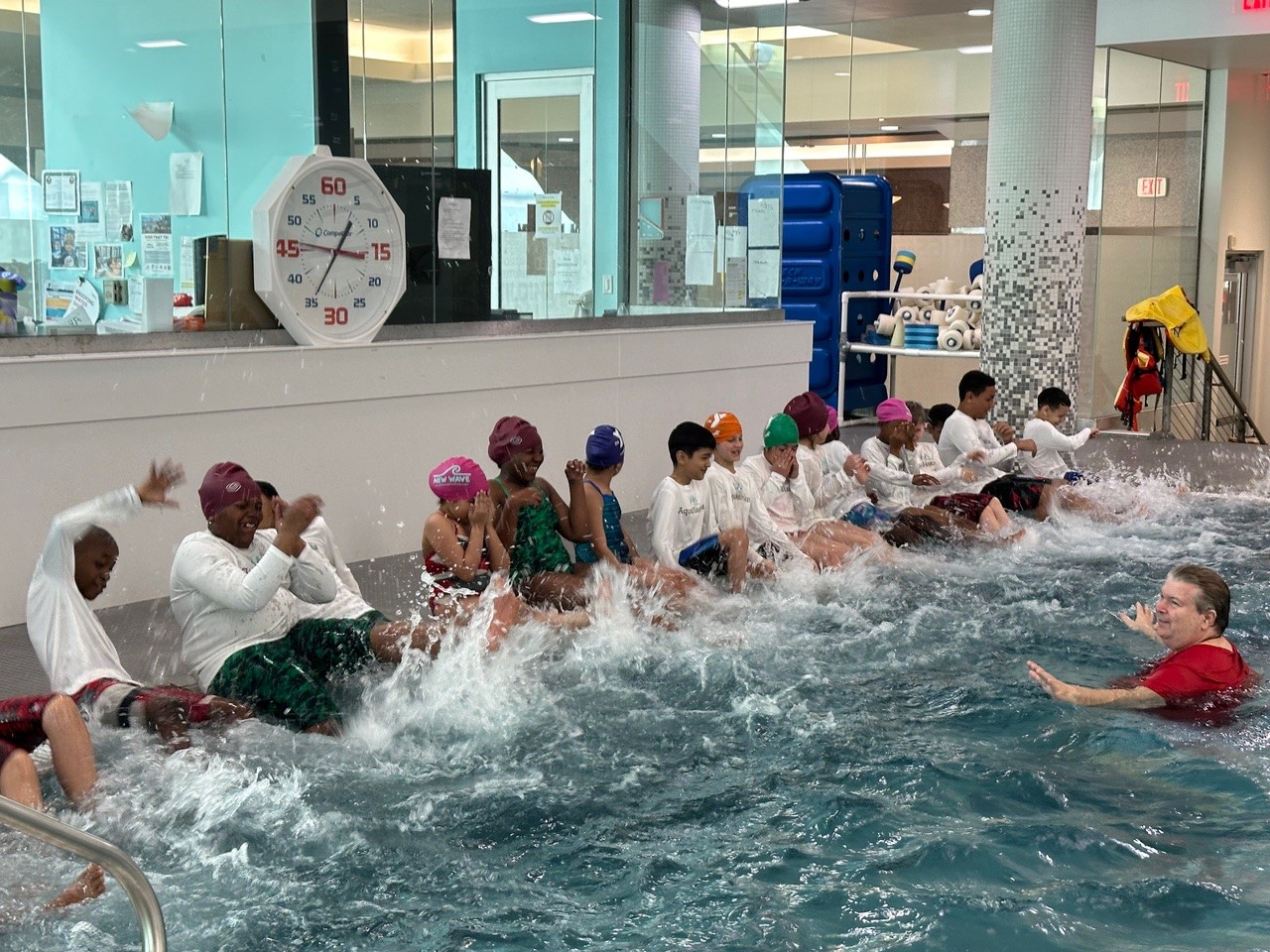 children splashing in pool during Aquamissions training