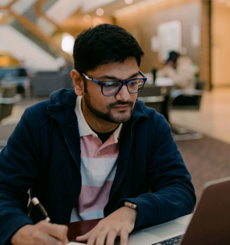 Graduate student studies on laptop
