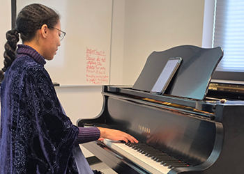 Music Therapy Student at a Piano
