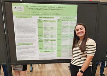 Female Music Therapy Student Presenting at the Undergraduate Research Symposium