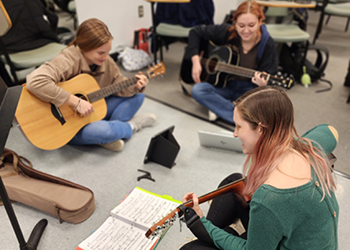 Three Female Music Therapy Students with Guitars