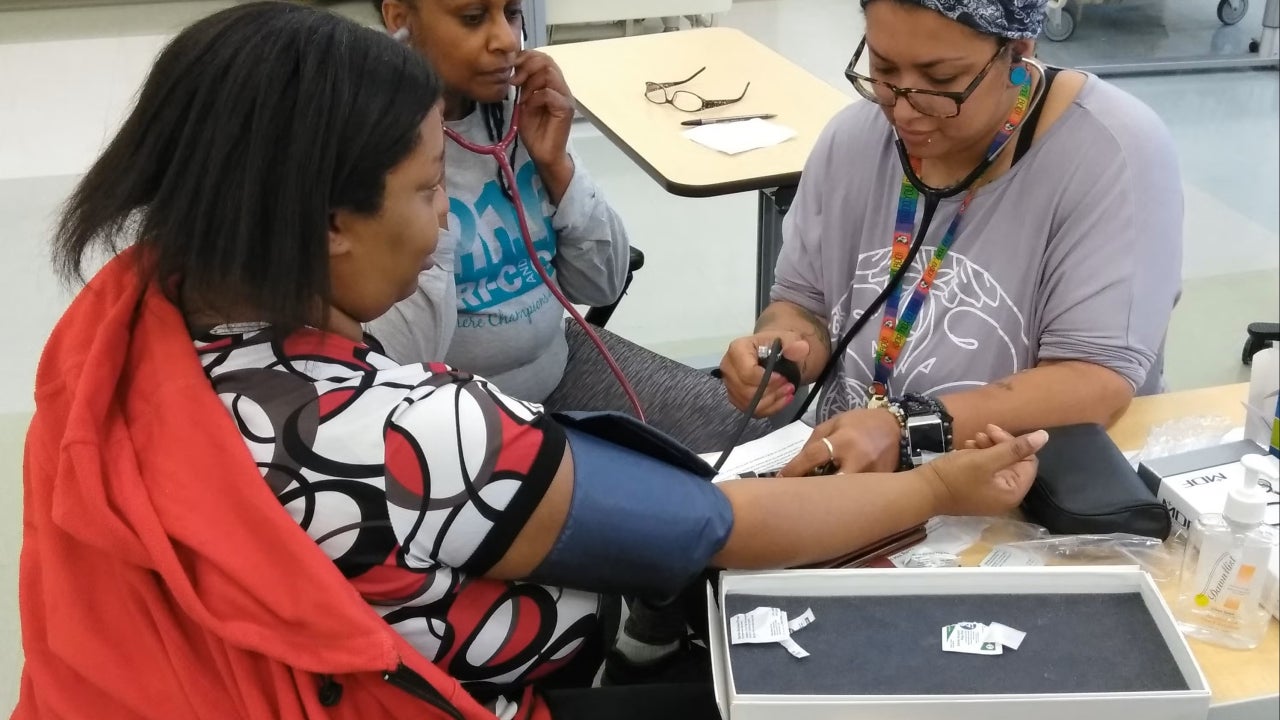 Community Health Workers learning to take blood pressure