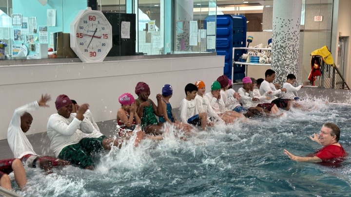 children splashing in pool during Aquamissions training