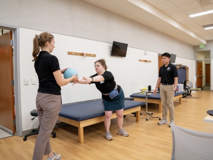 Physical therapy activity for balance with two students and one client