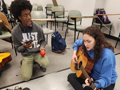 Music Therapy Students - one with maracas and one with a guitar